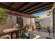 Cozy patio with table, chairs, and grill at 1116 E Belmont Ave, Phoenix, AZ 85020