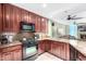Well-equipped kitchen with dark wood cabinets and granite counters at 120 E Rio Salado Pkwy # 201, Tempe, AZ 85281