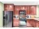 Modern kitchen with black appliances and wood cabinets at 120 E Rio Salado Pkwy # 201, Tempe, AZ 85281