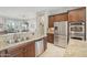 Kitchen with granite countertops, stainless steel appliances, and double sink at 13518 W Sola Dr, Sun City West, AZ 85375