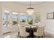 Elegant dining room with chandelier, round table, and view of the backyard at 17662 E Blaze Ln, Rio Verde, AZ 85263