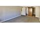 Spacious bedroom with grey carpet and barn door leading to bathroom at 7820 E Camelback Rd # 204, Scottsdale, AZ 85251