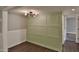 Entryway with light green wall paneling and dark hardwood floors at 7820 E Camelback Rd # 204, Scottsdale, AZ 85251