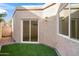 Private backyard with artificial turf and sliding glass door access at 5560 N 73Rd Pl, Scottsdale, AZ 85250