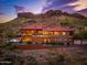 Luxury home with a pool and mountain views at dusk at 4551 S Avenida Corazon De Oro --, Gold Canyon, AZ 85118