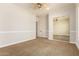 Well-lit bedroom with mirrored closet doors and ceiling fan at 2634 N 141St Ln, Goodyear, AZ 85395