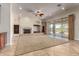 Living room with fireplace, built-ins, and sliding doors to patio at 2634 N 141St Ln, Goodyear, AZ 85395