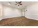 Spacious bedroom with ceiling fan and carpet flooring at 2634 N 141St Ln, Goodyear, AZ 85395