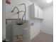 Laundry area with cabinets and an AO Smith water heater at 4331 W Port Au Prince Ln, Glendale, AZ 85306