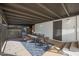 Covered patio with dining table and chairs next to storage at 4331 W Port Au Prince Ln, Glendale, AZ 85306