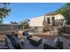 Relaxing backyard with deck, patio furniture and a view of the home at 4331 W Port Au Prince Ln, Glendale, AZ 85306