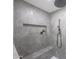 Spa-like shower with gray tile, built-in shelving, and a bench seat at 4331 W Port Au Prince Ln, Glendale, AZ 85306