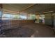 Empty horse stall with metal walls and dirt floor at 4331 W Port Au Prince Ln, Glendale, AZ 85306