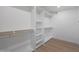Bright walk-in closet with built-in shelves and hanging rods at 4331 W Port Au Prince Ln, Glendale, AZ 85306