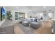Relaxing living room with sectional sofa, large TV, and hardwood floors at 4331 W Port Au Prince Ln, Glendale, AZ 85306