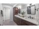 Elegant bathroom with double vanity, dark brown cabinets, and a large mirror at 4331 W Port Au Prince Ln, Glendale, AZ 85306