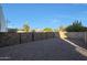 Gravel side yard with rock retaining wall and privacy fence at 4331 W Port Au Prince Ln, Glendale, AZ 85306