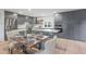 Modern kitchen with gray cabinets, stainless steel appliances, and an island with seating at 4331 W Port Au Prince Ln, Glendale, AZ 85306