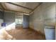 Empty horse stall with metal walls and dirt floor at 4331 W Port Au Prince Ln, Glendale, AZ 85306