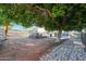 Spacious backyard with large tree and patio seating area at 4331 W Port Au Prince Ln, Glendale, AZ 85306