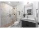 Modern bathroom with marble shower, floating vanity, and black accents at 4331 W Port Au Prince Ln, Glendale, AZ 85306
