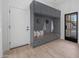 Modern entry with built-in bench, gray cabinets, and hardwood floors at 4331 W Port Au Prince Ln, Glendale, AZ 85306