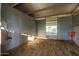 Empty horse stall with metal walls and dirt floor at 4331 W Port Au Prince Ln, Glendale, AZ 85306