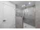Modern shower with glass enclosure, gray marble tile, and rainfall shower head at 4331 W Port Au Prince Ln, Glendale, AZ 85306