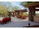 Relaxing poolside patio with comfortable seating and umbrellas at 2549 W Shinnecock Way, Anthem, AZ 85086