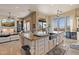 Open kitchen with large island, stainless steel appliances, and views to the living room at 2549 W Shinnecock Way, Anthem, AZ 85086