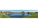 Expansive lake view with lush landscaping and mountains in the background at 2549 W Shinnecock Way, Anthem, AZ 85086