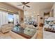 Spacious living room with comfortable seating, coffee table and views to the kitchen at 2549 W Shinnecock Way, Anthem, AZ 85086