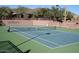 Well-maintained tennis court with seating area at 2549 W Shinnecock Way, Anthem, AZ 85086