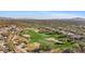 Aerial view of houses and a golf course with mountain views at 2549 W Shinnecock Way, Anthem, AZ 85086