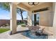 Cozy patio with a bistro set and a view of the well-maintained backyard at 2549 W Shinnecock Way, Anthem, AZ 85086