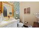 Elegant powder room with a marble sink and gold accents at 2549 W Shinnecock Way, Anthem, AZ 85086
