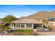 House's back elevation with covered patio, pool, and mountain views at 2549 W Shinnecock Way, Anthem, AZ 85086