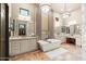 Spa-like bathroom with double vanities and a large soaking tub at 2549 W Shinnecock Way, Anthem, AZ 85086