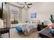 Comfortable guest bedroom with a queen-size bed and plenty of natural light at 2549 W Shinnecock Way, Anthem, AZ 85086