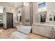 Elegant bathroom with double sinks, a large soaking tub, and a glass-block shower at 2549 W Shinnecock Way, Anthem, AZ 85086