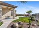 Landscaped backyard with artificial turf, pathways and a seating area at 2549 W Shinnecock Way, Anthem, AZ 85086
