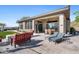 Spacious covered patio with seating and dining areas, adjacent to the house at 2549 W Shinnecock Way, Anthem, AZ 85086