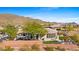 Aerial view showcasing house's backyard oasis, patio, and mountain backdrop at 2549 W Shinnecock Way, Anthem, AZ 85086