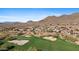 Aerial view of community with golf course and mountain views at 2549 W Shinnecock Way, Anthem, AZ 85086