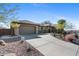 Single story home with a two-car garage and desert landscaping at 2549 W Shinnecock Way, Anthem, AZ 85086
