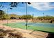 Tennis court with spectator seating and mountain views at 2549 W Shinnecock Way, Anthem, AZ 85086