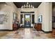 Elegant entryway with tile floors, a chandelier, and a view of the backyard at 2549 W Shinnecock Way, Anthem, AZ 85086