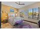Bright bedroom with a comfortable bed and large windows at 2549 W Shinnecock Way, Anthem, AZ 85086