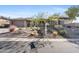 Single story home with a two-car garage and xeriscaped front yard at 2549 W Shinnecock Way, Anthem, AZ 85086