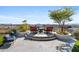 Elegant backyard patio with seating area, fire pit, and mountain views at 2549 W Shinnecock Way, Anthem, AZ 85086